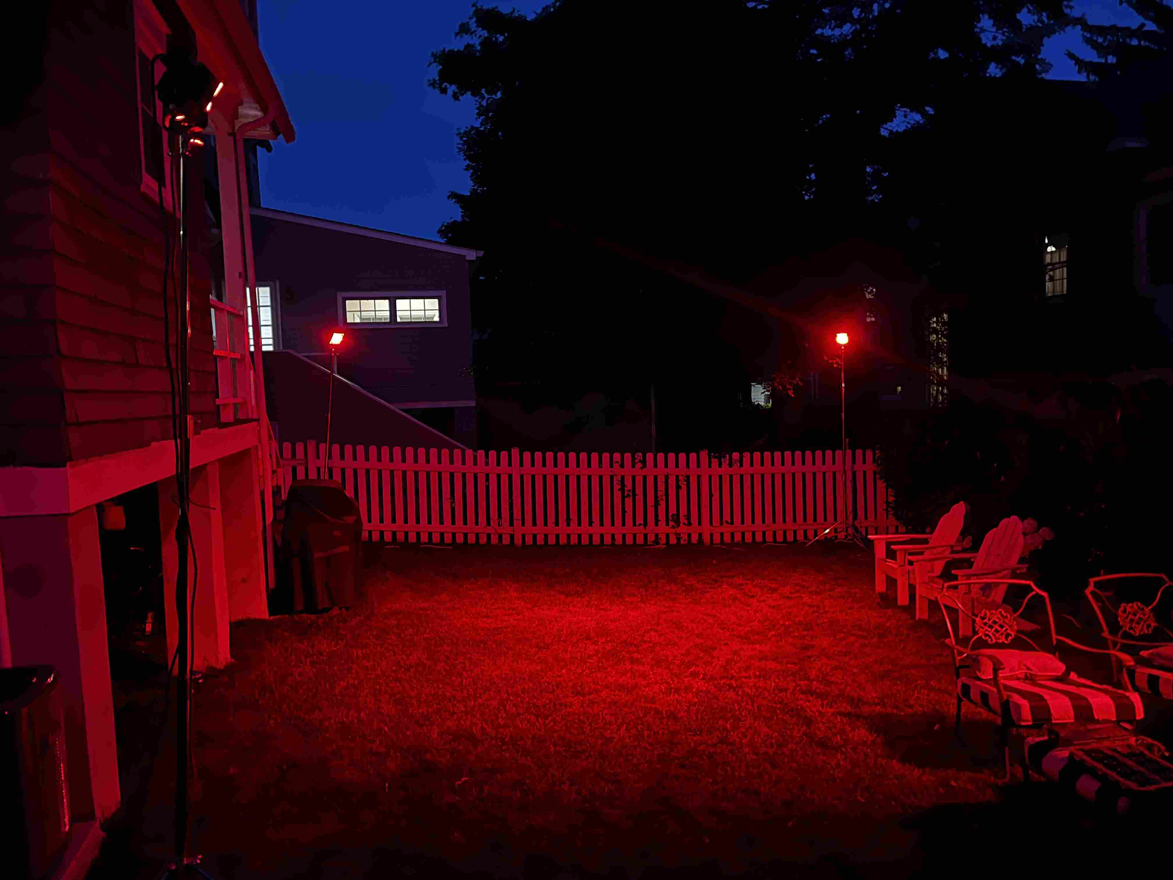 An image of a backyard light up using led lights setup by Hudson Schlumberger.