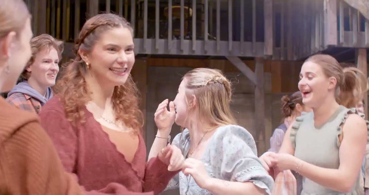 The company of The Comedy of Errors mid-scene on the timber set
