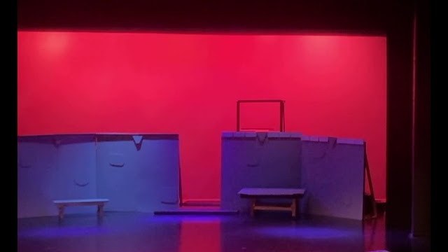 A red wash across the back wall with violet light on the deck, Romeo and Juliet