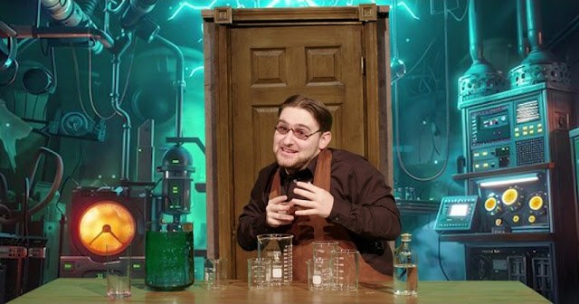 A man at a bench of beakers in front of a glowing green laboratory set