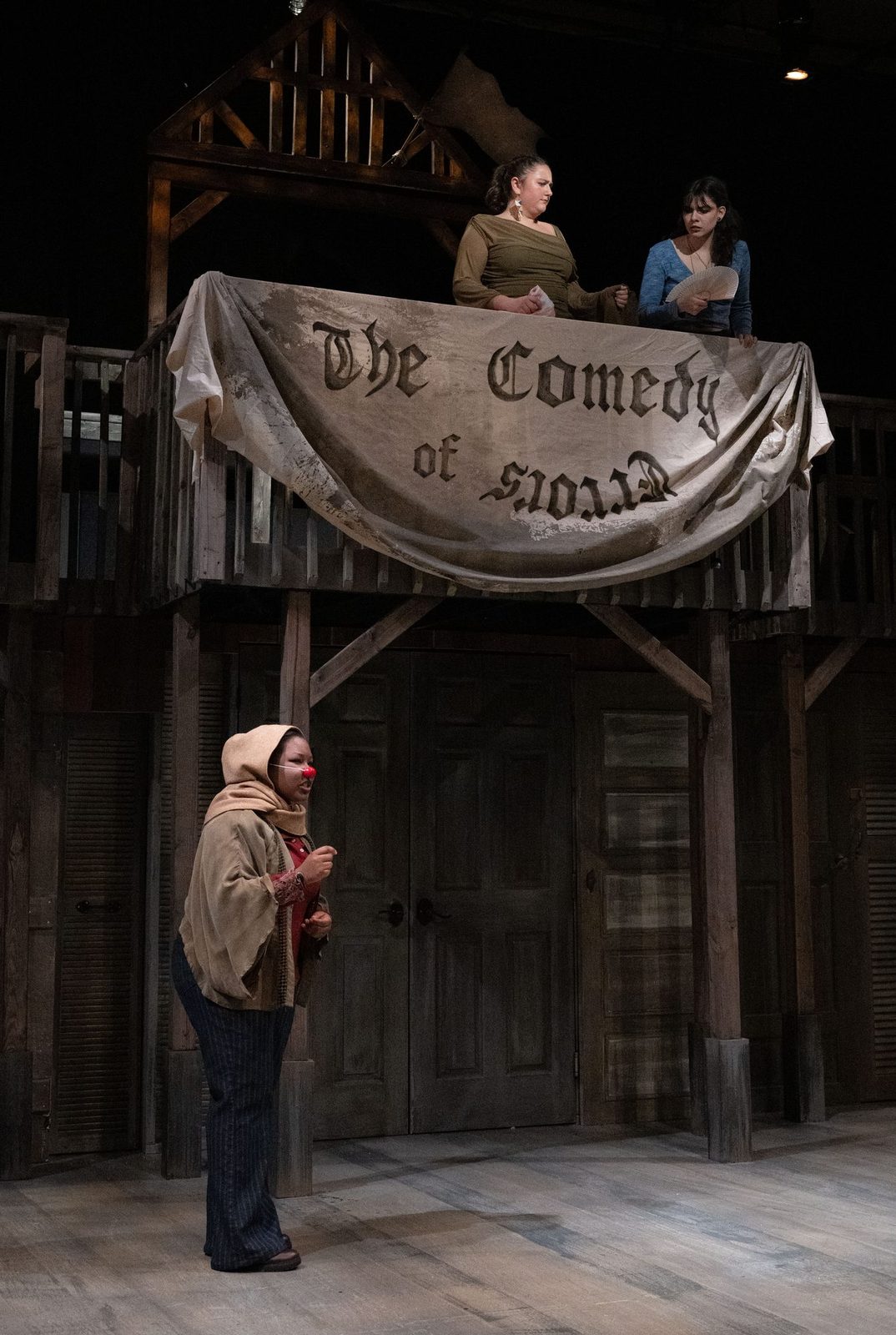 The company lit beneath the hand-painted banner