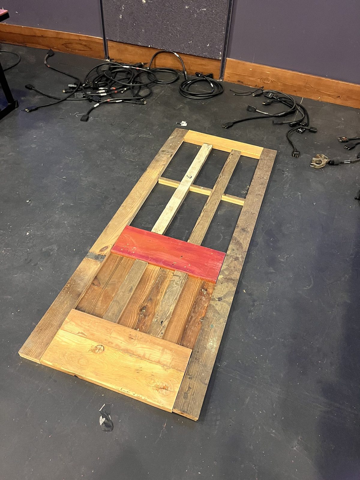 The built door laid flat on the floor, painted in panels