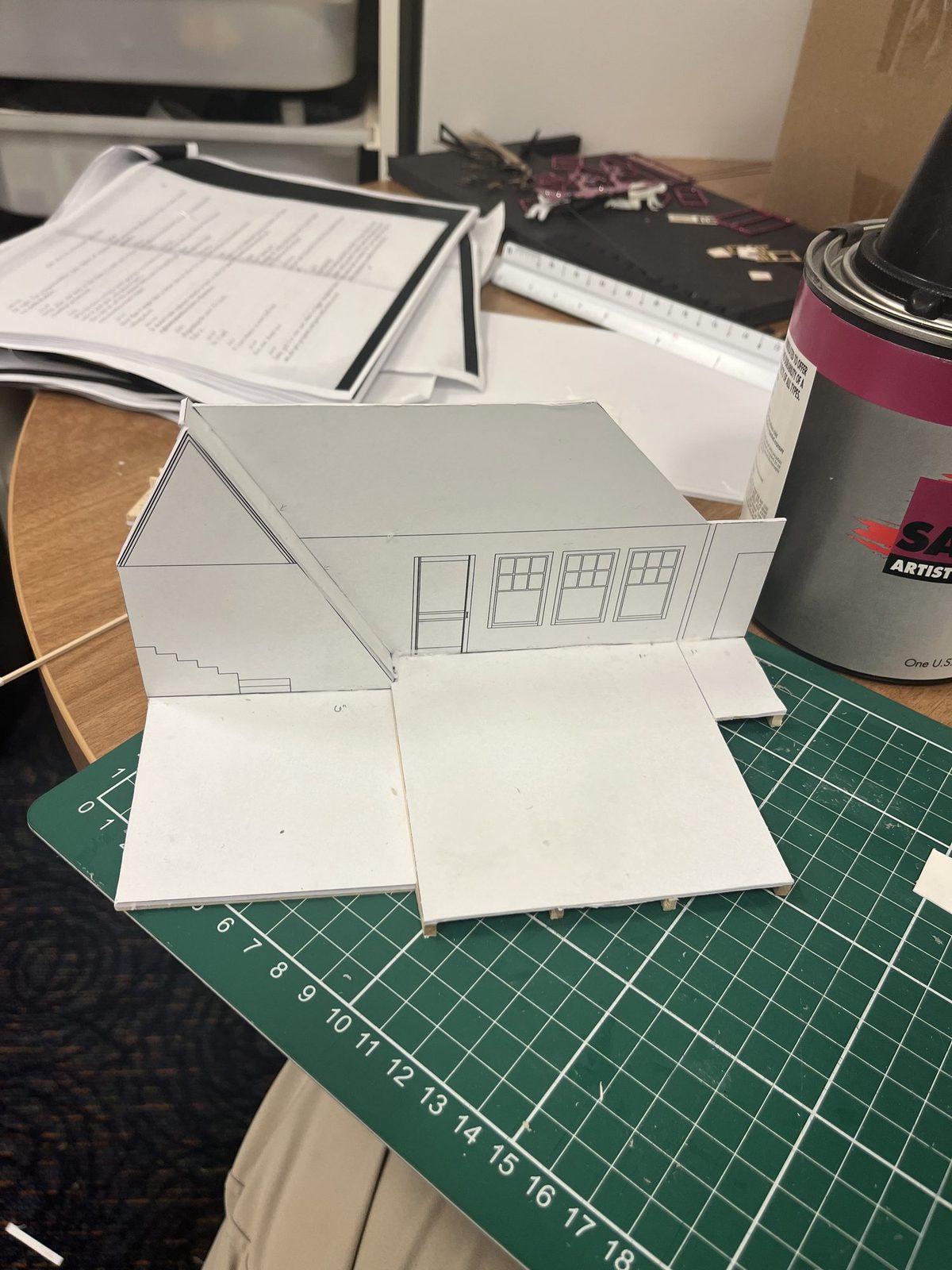 The white model part-assembled on the workbench