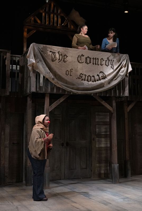 The company lit beneath the hand-painted banner