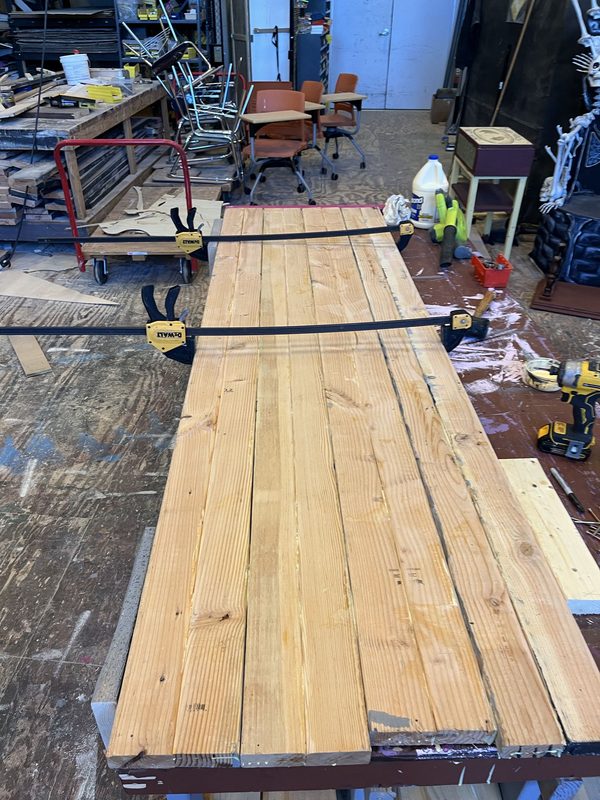 The table top clamped up across the bench while the glue sets