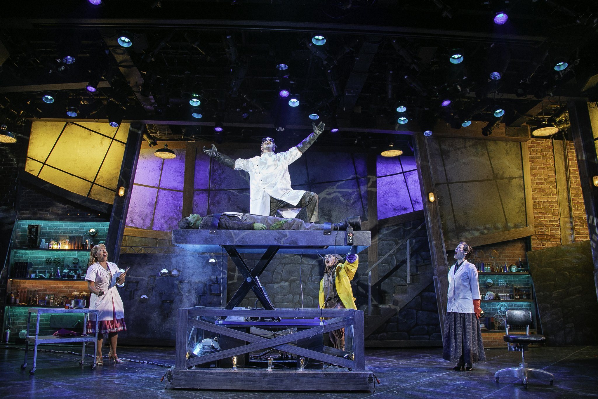 The laboratory scene from Young Frankenstein: the scientist on the slab with his arms raised, the creature laid out below him