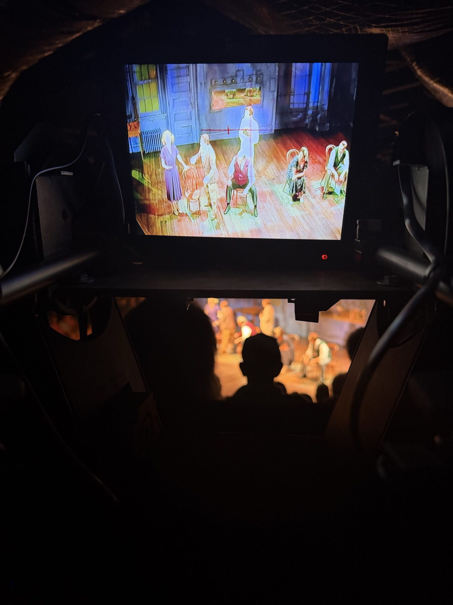 The remote followspot station: a monitor mounted on the yoke showing the stage from the fixture's point of view, with a grip handle either side